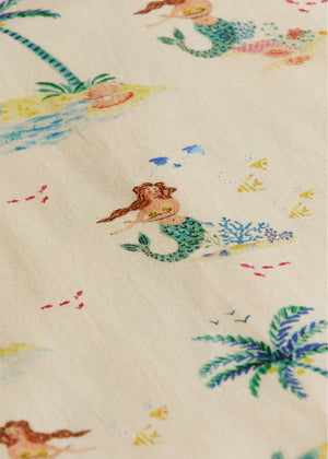 The Baby Girls' Flynn Shirt by Arsene & Les Pipelettes features a playful mermaid, palm tree, fish, and island print on light beige fabric—perfect for little ones.