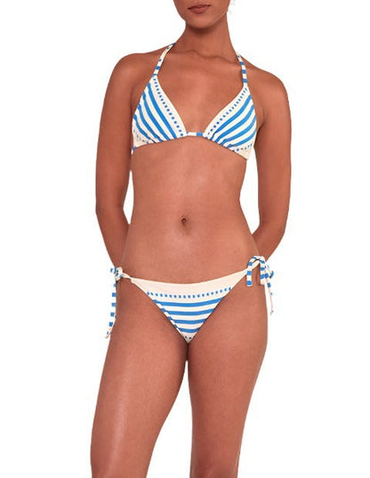 A person wearing the Lemlem Malia Top and Rekka Bottom Bikini, in responsibly-made blue and white stripes, stands with arms at their sides, highlighting the adjustable string tie design.