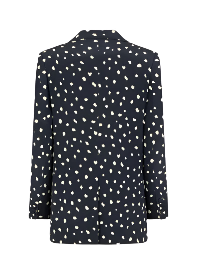 The Mariquita Everyday Blazer by Blaze Milano features black fabric with white irregular polka dots, shown from the back.