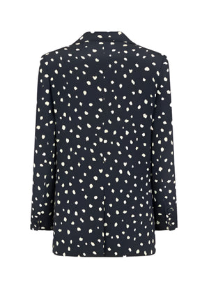 The Mariquita Everyday Blazer by Blaze Milano features black fabric with white irregular polka dots, shown from the back.
