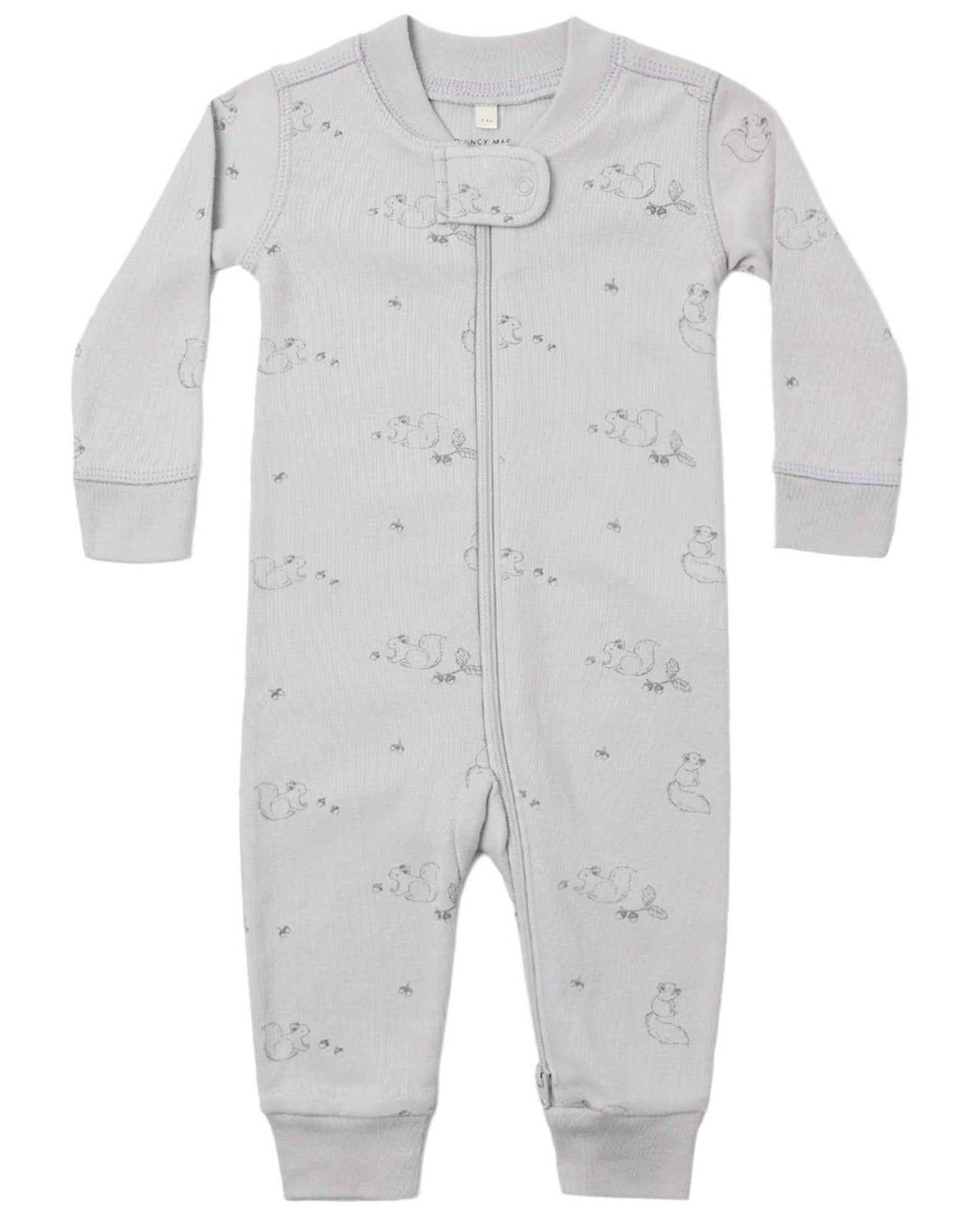 The Quincy Mae Baby Zip Long Sleeve Sleeper is a light grey baby romper crafted from soft organic brushed jersey. It features long sleeves, a front zipper, and a subtle animal print pattern, and is designed with non-slip soles to provide added safety for little ones taking their first steps.