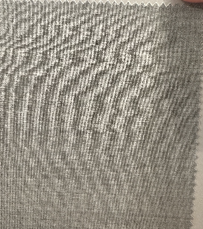 A close-up of a light grey, textured fabric swatch with a zigzag edge—ideal for crafting Samuelsohn's Slim Fit Flat Front Wool Pants, designed for a sleek look with an unfinished hem.