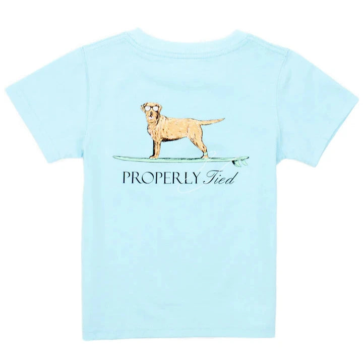 Light blue Boys' Short-Sleeve Tee by Properly Tied, made with soft Pima cotton and showcasing hand-drawn graphics of a dog on a surfboard above "Properly Tied.