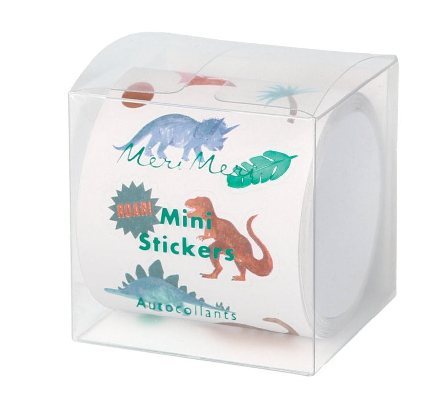 A box of Meri Meri Themed Stickers includes dinosaur-themed mini stickers with various dinosaurs and leaves, ideal for decorating posters or adding a fun touch to party bags.