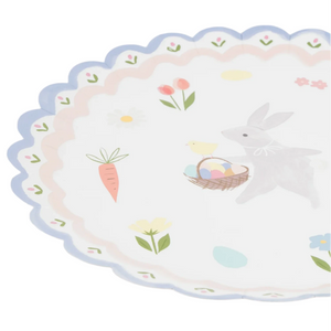 The Easter Bunny Dinner Plates by Meri Meri boast a charming scalloped design with the Easter Bunny, chick, carrots, flowers, and colorful eggs—ideal for adding cheer to your Easter dinner table!.