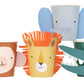 Four colorful Meri Meri Party Cups decorated with animal faces: a monkey (left), a lion (center), an elephant (top), and a crocodile (right). Perfect as party favors for any children's party by Meri Meri.