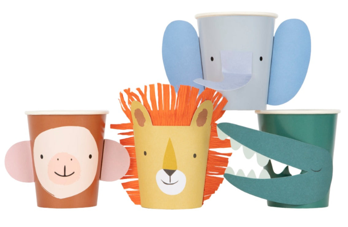 Four colorful Meri Meri Party Cups decorated with animal faces: a monkey (left), a lion (center), an elephant (top), and a crocodile (right). Perfect as party favors for any children's party by Meri Meri.