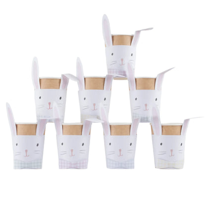 A stack of eight "Lop Eared Bunny Cups" by Meri Meri, featuring white bunny faces and charming lop ears, arranged in a pyramid.