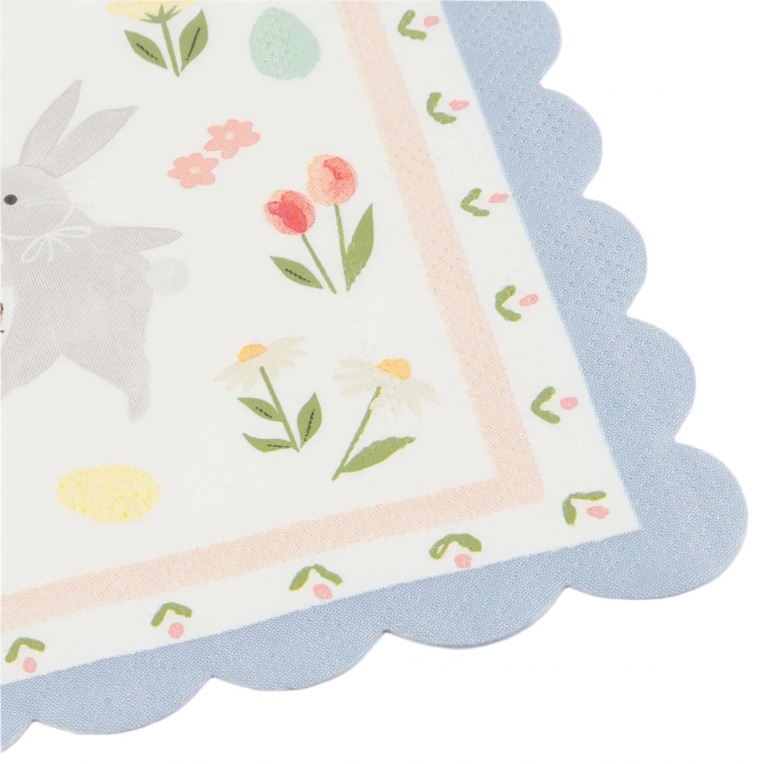 The Meri Meri Easter Bunny Large Napkins feature a scalloped blue edge and depict the Easter Bunny surrounded by lively flowers and colorful pastel Easter eggs.