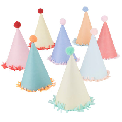 A playful set of eight Meri Meri Party Hats, each featuring vibrant colors with pom-poms on top and fringe at the base, ideal for any dinosaur-themed celebration.