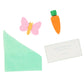 The Gingham Bow Bunny Crackers by Meri Meri showcase a pink butterfly eraser, an orange carrot eraser, a mint green paper triangle, and a card with an egg joke about hating "Fry-days" for a delightful springtime touch.