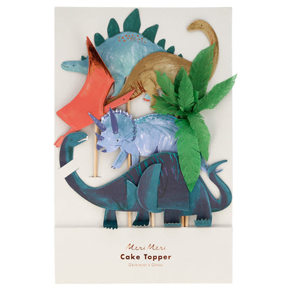 The Meri Meri Cake Toppers from the brand Meri Meri feature a set of four colorful dinosaur designs with leafy green accents, packaged on a white background—perfect for any animal-loving celebration.