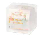 This clear box contains a roll of "Meri Meri Themed Stickers," ideal for infusing a whimsical fairy-tale theme into party bags or adorning posters with charm and delight.