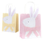 Meri Meri's Easter Party Bags include two adorable bags with whimsical rabbit designs—one in cheerful yellow and the other in pastel pink. Featuring 3D bows and bunny ears, they're perfect for an Easter egg hunt.