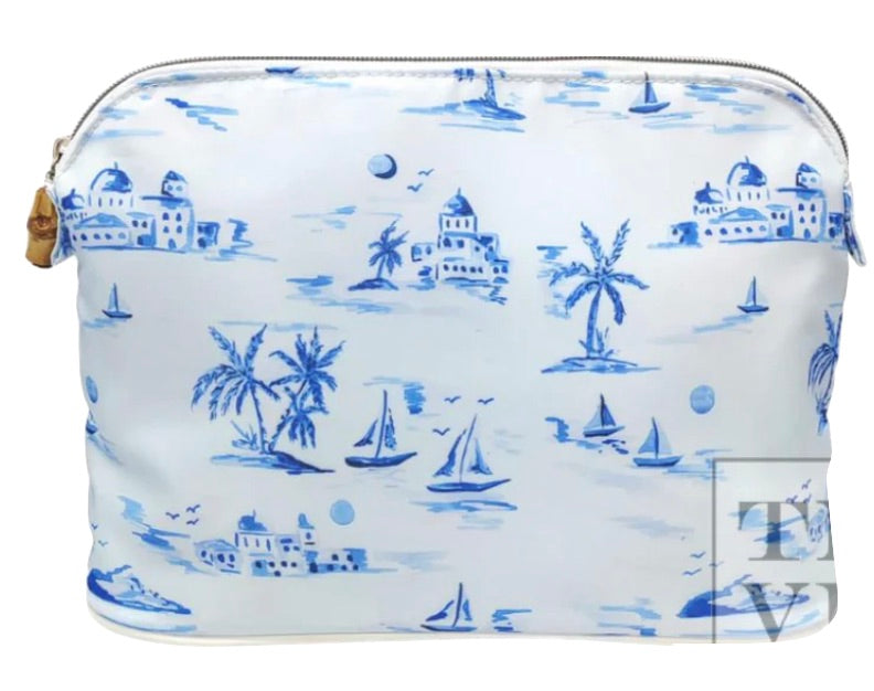 TRVL Bag from the Cote D'Azur Collection with a blue nautical pattern featuring sailboats, palm trees, and buildings, with a dome top zip closure.