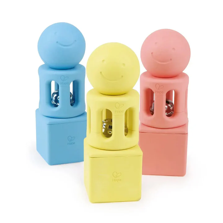 The Hape Geometric Rattle Trio includes three rattles in blue, yellow, and pink with square bases and round heads, offering an engaging way to develop hand-eye coordination; shown on a white background.