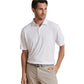 A man wears a Peter Millar Featherweight Mélange Polo with UPF 50+ sun protection, tucked into light beige pants and styled with a grey belt, standing with one hand in his pocket.