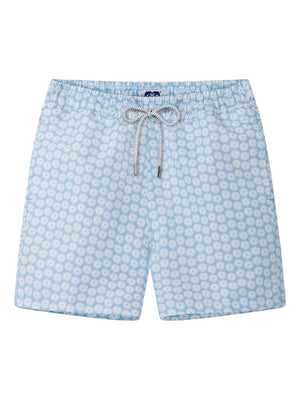 The Staniel Swim Trunk by Love Brand features a light blue quick-dry fabric with a white geometric floral pattern, an elastic waistband, and a drawstring with metal tips—ideal for comfortable summer swimming.