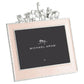 The Michael Aram Animals Nickelplate Frame, 5x7 in pink, features a silver finish with metal animal figures—lion, elephant, giraffe, and rhinoceros—making it perfect for displaying cherished children’s memories.