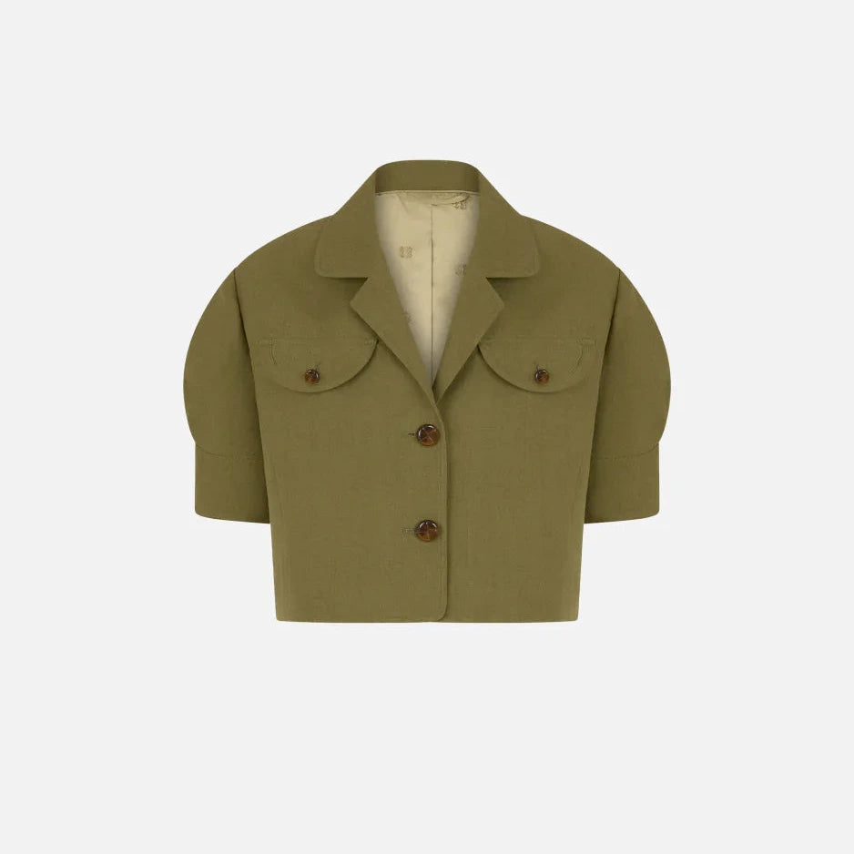 Blaze Milano’s Midday Sun Lola Jacket, a cropped olive green linen piece, features short sleeves, padded shoulders, a notched collar, two brown buttons, and front flap pockets—all shown on a plain background.