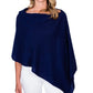 A woman wearing a navy Alashan Cashmere cashmere dress topper poncho for a versatile day-to-night wardrobe.