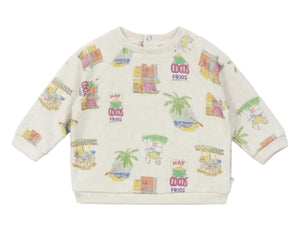 The Baby Sweatshirt by Arsene & Les Pipelettes is a cream-colored, long-sleeve piece made from organic cotton, adorned with vibrant illustrations of palm trees, carts, and the "HAY FRIOS" text playfully scattered across its soft fabric.