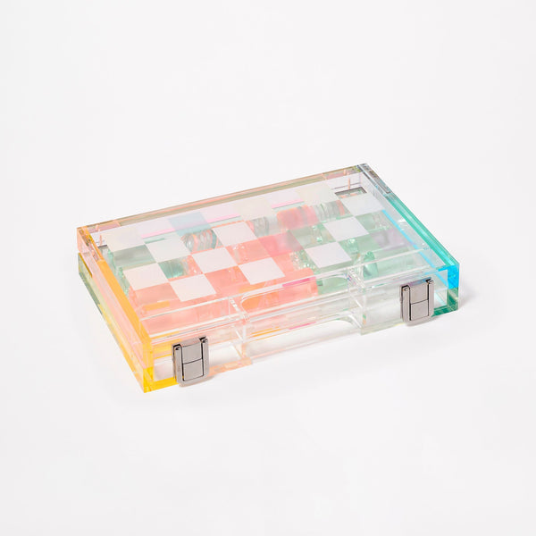 The Sunnylife Mini Lucite Chess and Checkers, Aurora by Sunnylife adds a whimsical twist with its transparent Lucite design and pastel checkerboard pattern, making it perfect for the luxury game set enthusiast.