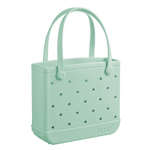 The Baby Bogg Bag by Bogg Bags is a light green, rectangular tote featuring perforated holes, dual handles, and "bogg" embossed near the base—a washable bag that’s stylish and practical.