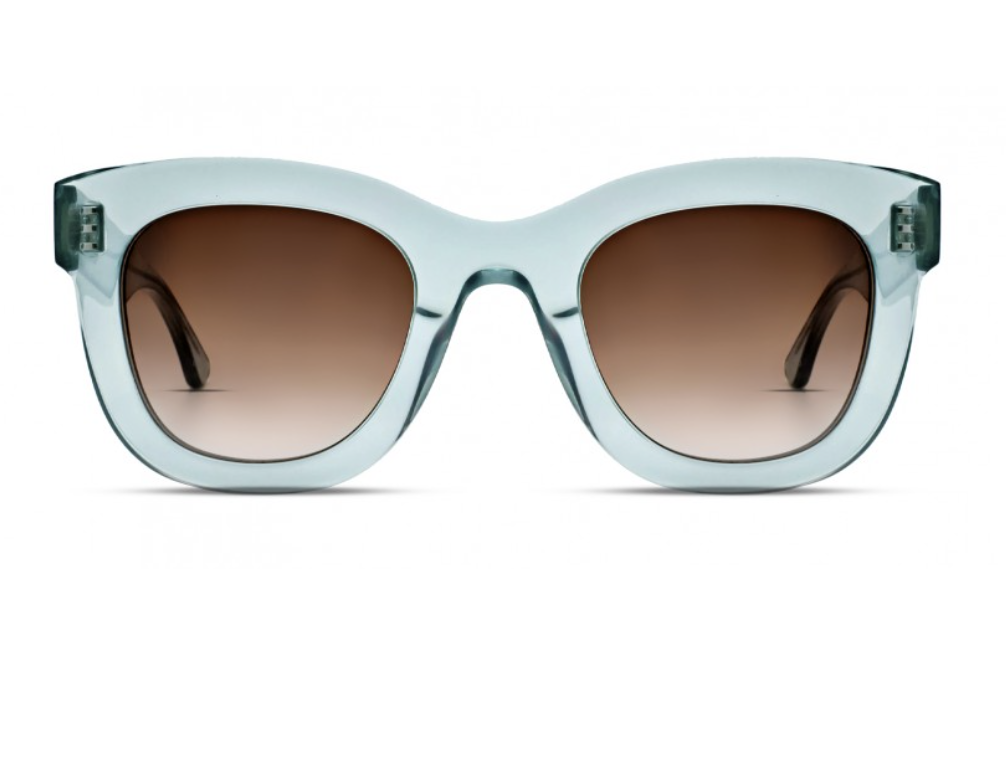 Front view of Thierry Lasry Gambly Sunglasses with light blue translucent handcrafted Italian acetate frames and brown gradient lenses by Thierry Lasry.