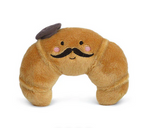 Monsieur Croissant by Mon Ami is a plush toy featuring embroidered eyes, a mustache, rosy cheeks, and a tiny fabric beret. This adorable French stuffed animal adds charm to any space and is photographed on a white background.