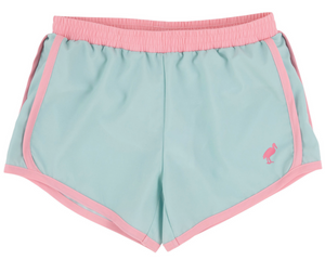 The Beaufort Bonnet Company’s Girls' Prepletic™ Shimmy Shake Shorts are light blue track shorts with pink trim and waistband, featuring a small flamingo logo on the front left leg.