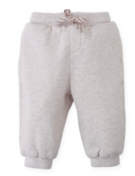 The Gingersnaps Baby Boys’ Alessio French Terry Jogger Pants in light beige are crafted from soft French terry and feature an elastic waistband, decorative drawstring, and cuffed ankles, shown against a white background.