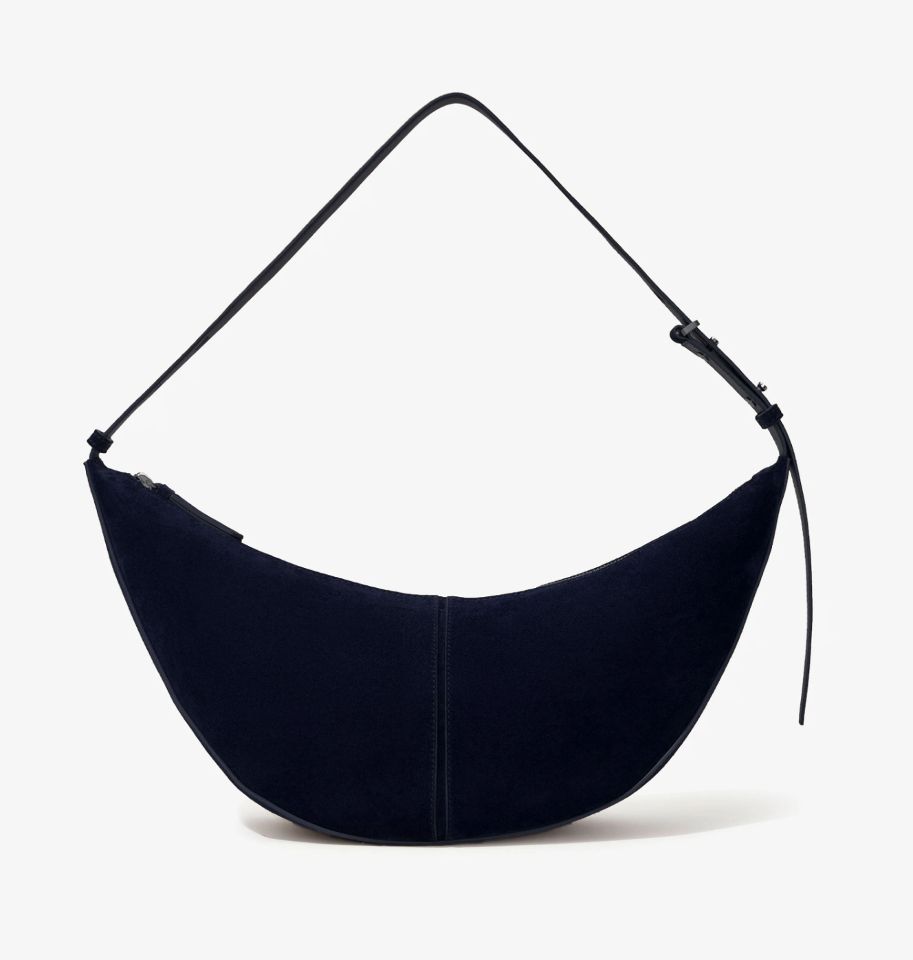 The Proenza Schouler Slide Suede Bag features a crescent shape, soft suede construction, single adjustable strap, and curved silhouette, shown against a plain white background.