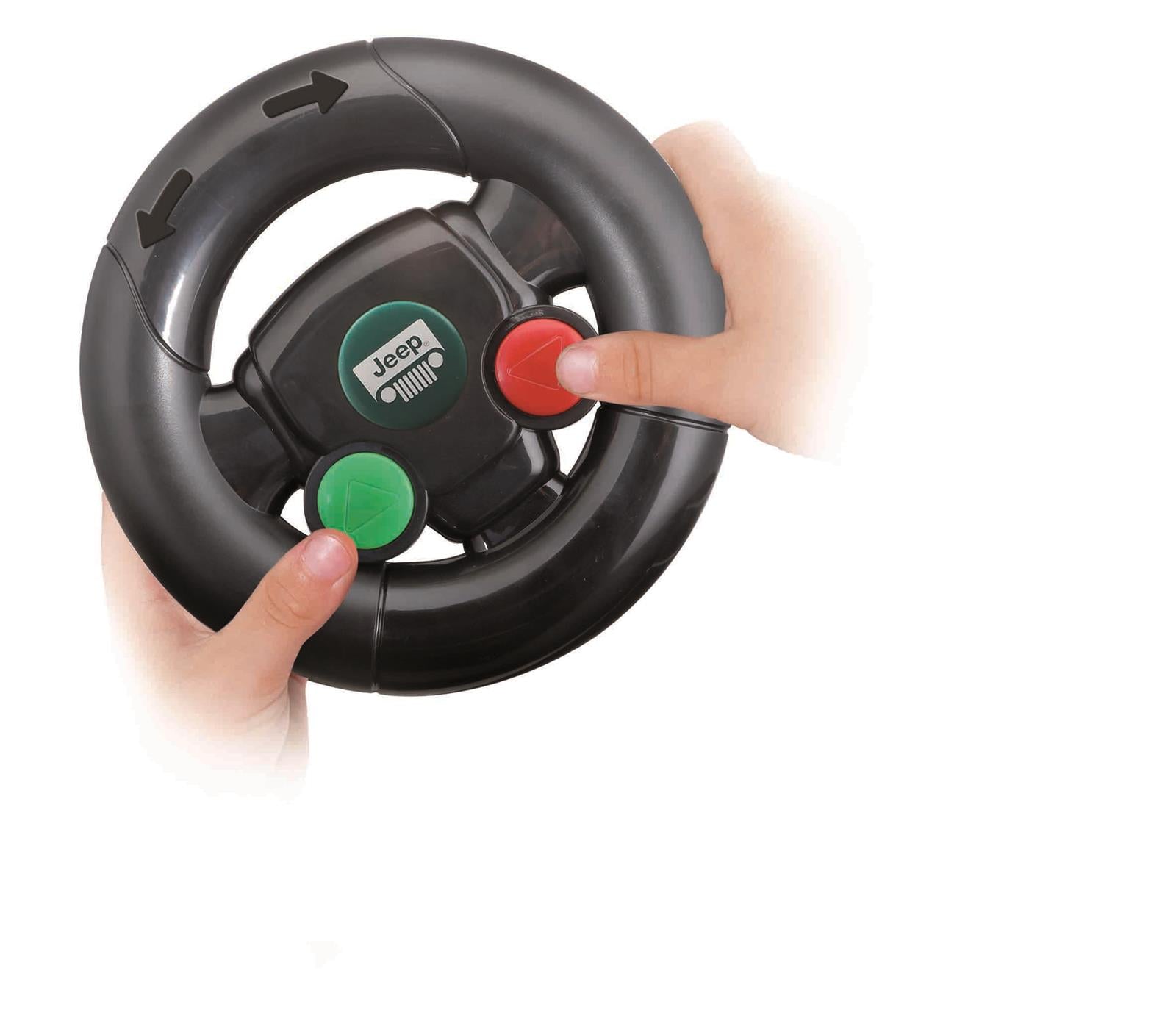 A child’s hands hold a black toy steering wheel featuring a green button, a red button, and black directional arrows—just like the remote included with the Maisto My First RC Jeep Wrangler.