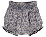 The Kidiwi Baby Girls' Myrtille Smocked Bloomer features a navy blue floral print, 100% cotton fabric, an elastic waistband, and delicate smocking at the top.