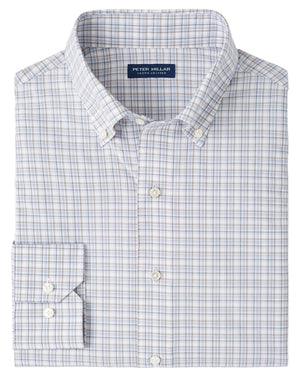 The Peter Millar Carter Performance Poplin Sport Shirt is a neatly folded men’s long-sleeve button-down in a blue, gray, and white plaid pattern with a Peter Millar label on the inside collar.