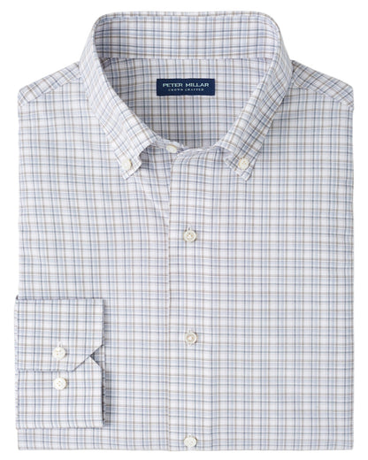 The Peter Millar Carter Performance Poplin Sport Shirt is a neatly folded men’s long-sleeve button-down in a blue, gray, and white plaid pattern with a Peter Millar label on the inside collar.
