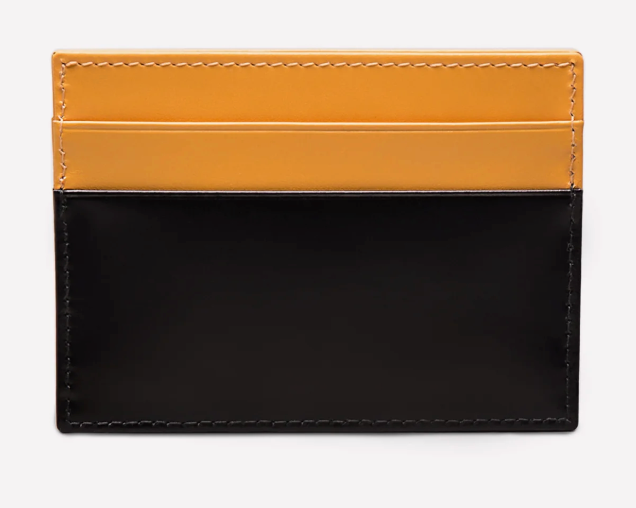 The Ettinger Bridle Flat Credit Card Case features a two-tone bridle hide leather design with a yellow upper section, black lower section, and visible stitching.