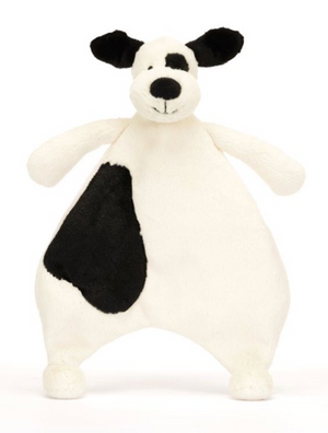 The Jellycat Bashful Black & Cream Puppy Comforter is a dog-shaped plush with floppy black ears, a black eye patch, and a large spot—made from soft recycled fibers, perfect for newborn snuggles.
