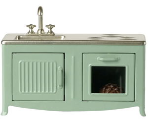 A compact mint green metal kitchen set by Maileg, designed for mice, featuring a sink, stovetop, toy oven (with a visible pie inside), and cabinet—perfect for imaginative play in the Mouse Hole Farmhouse.