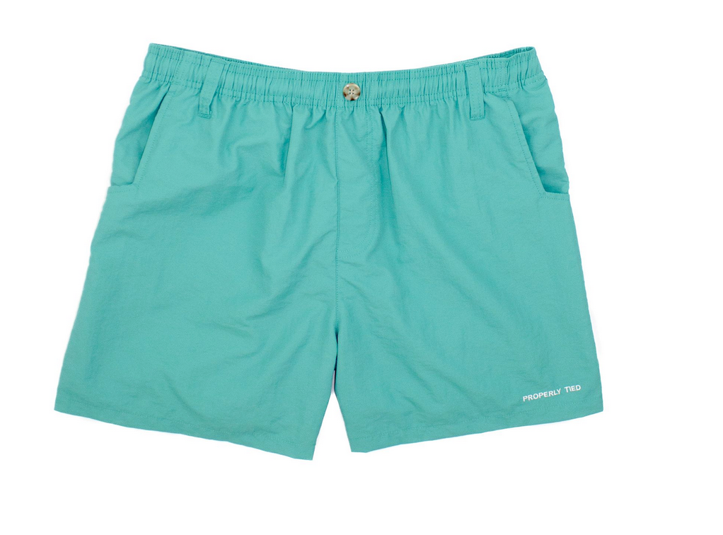 The Boys' Mallard Short by Properly Tied is teal, featuring an elastic waistband, belt loops, quick-dry fabric, side pockets, and a small "PROPERLY TIED" logo near the hem.