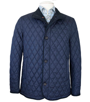 A Waterville Clay Diamond Quilt Jacket with a zip closure is displayed over a collared shirt.