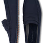 A pair of Peter Millar men's navy blue slip-on loafers, featuring breathable performance uppers, displayed against a white background.