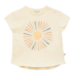 The Arsene & Les Pipelettes Baby Girls' Fleur T-Shirt is a cream-colored children's top made from soft organic cotton, featuring a pastel sun graphic and two buttons on the left shoulder.