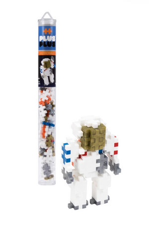 A Plus Plus Tube - Astronaut is displayed beside a small astronaut figure built from interlocking pieces, making it an ideal STEM toy for creative play and developing fine motor skills.