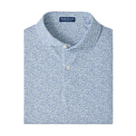 A folded Peter Millar Limoncello Performance Jersey Polo in a blue and white floral pattern, featuring a collared neckline with two buttons and four-way stretch for optimal comfort, displayed on a plain white background.