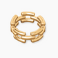 The Isabel Ring by Lie Studio is a timeless gold piece with an openwork design, showcasing interlinked rectangular segments, set against a white background.