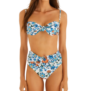 Woman wearing the Flora Tile Off White Bikini by Farm Rio, featuring a structured underwire top and high-waisted bottoms in white with blue and orange floral print.