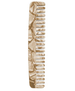 The Machete Comb No. 3 by Machete, a travel-size marbled beige hair comb made from exquisite Italian acetate, showcases both wide and narrow teeth and is presented flat against a pristine white background.