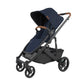 The UPPAbaby Cruz V2 Stroller, offered in navy blue with brown accents, features a sleek design that includes a canopy, four wheels for remarkable maneuverability, and an under-seat storage basket.